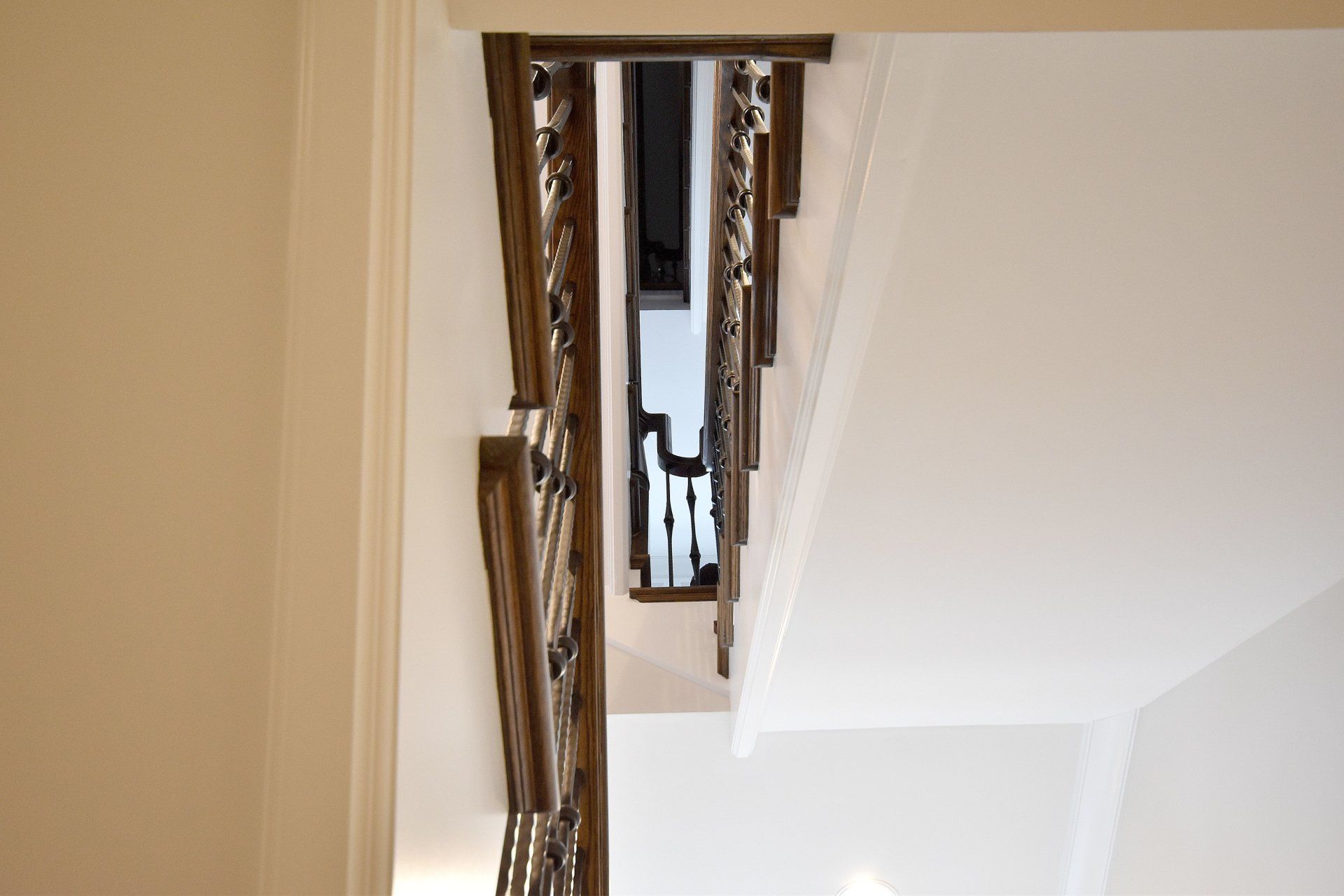 The stairs are made of wood and metal and are very tall.