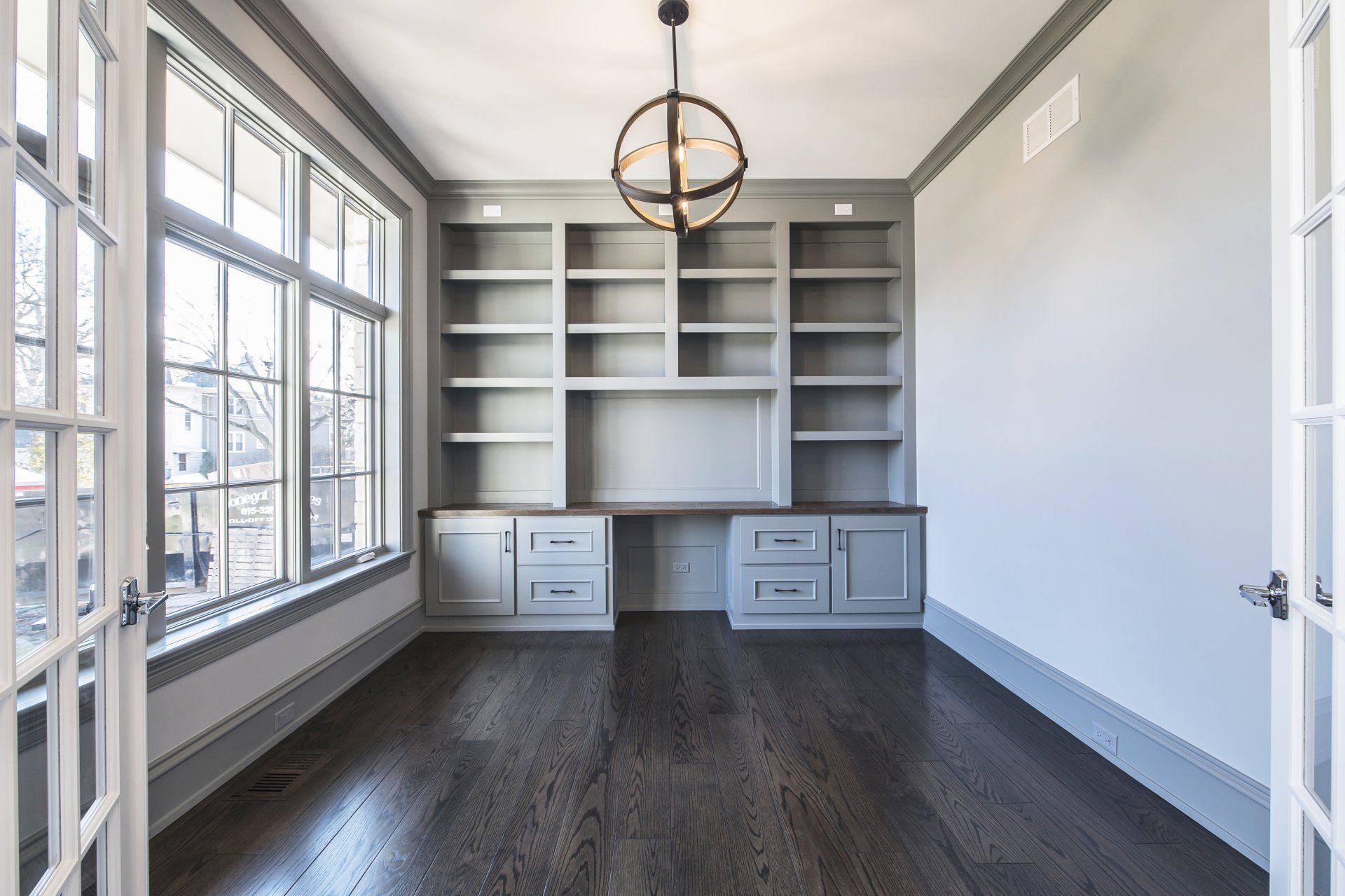 An empty room with a lot of shelves and a desk.