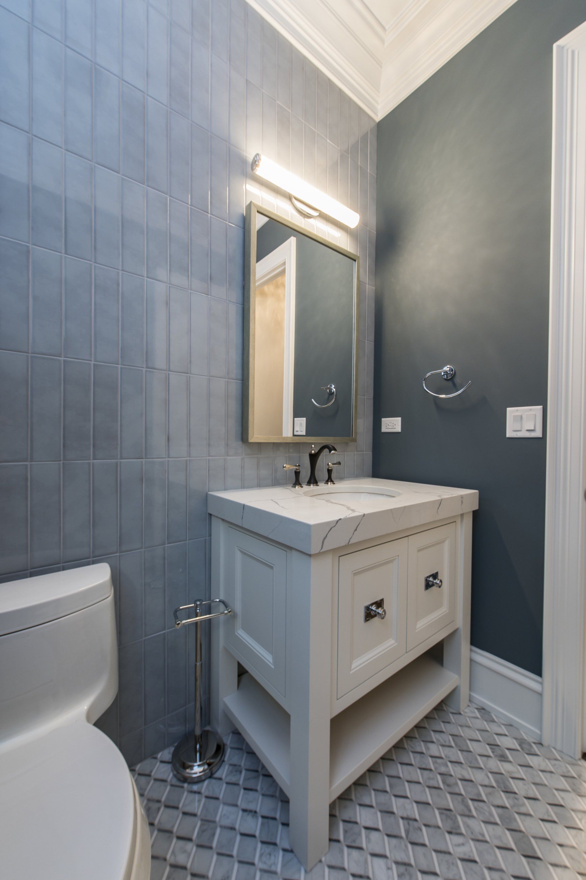 A bathroom with a toilet , sink and mirror