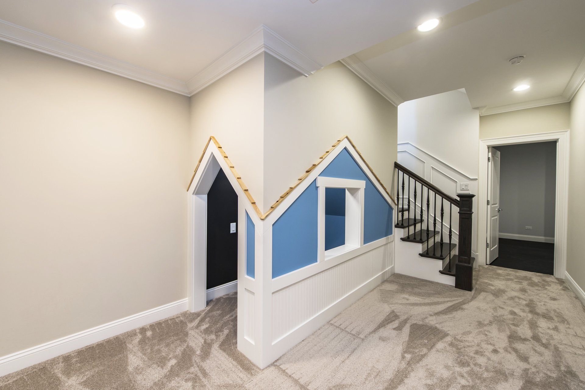 There is a playhouse in the corner of the room.