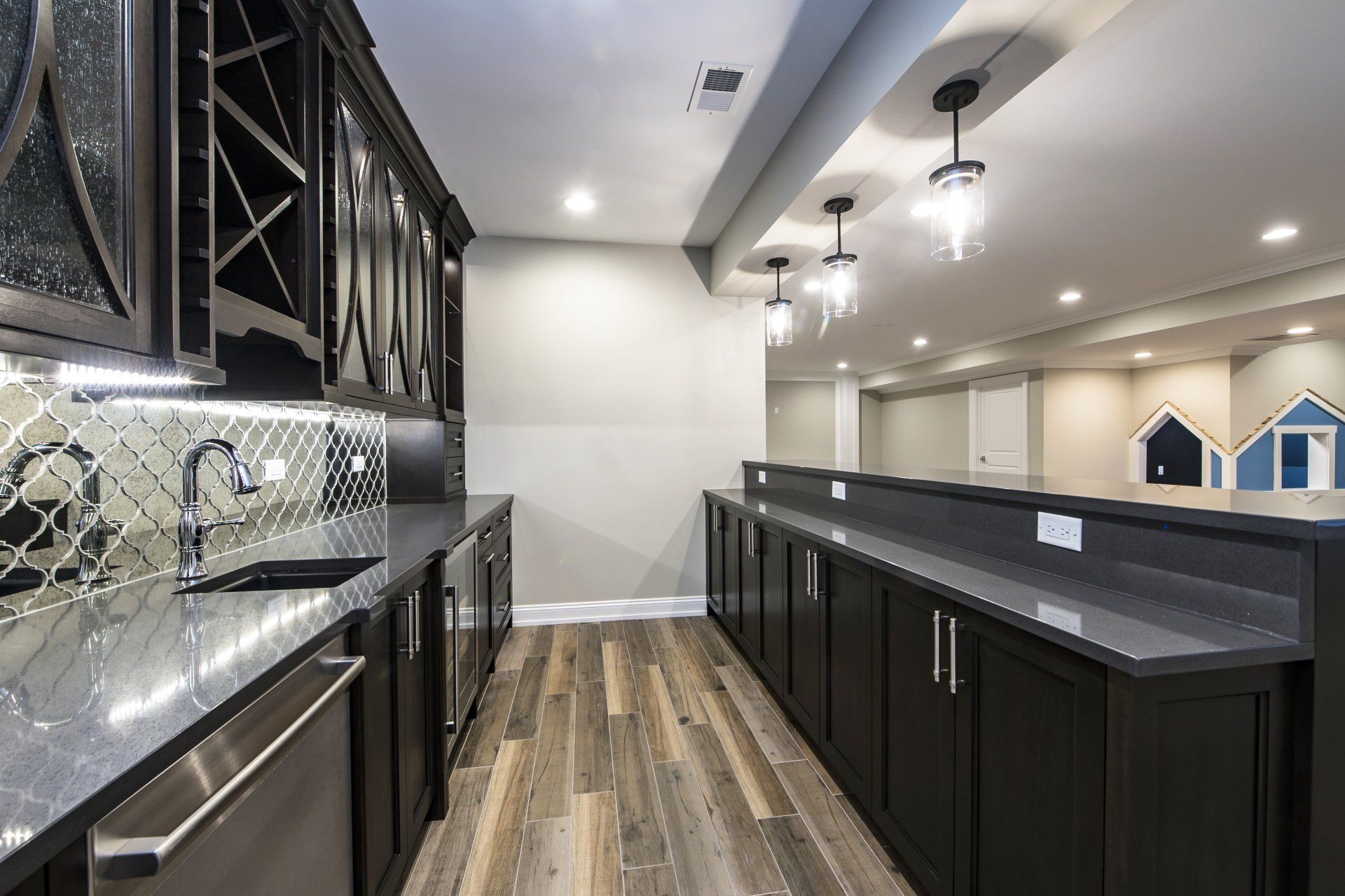 A kitchen with black cabinets and stainless steel appliances