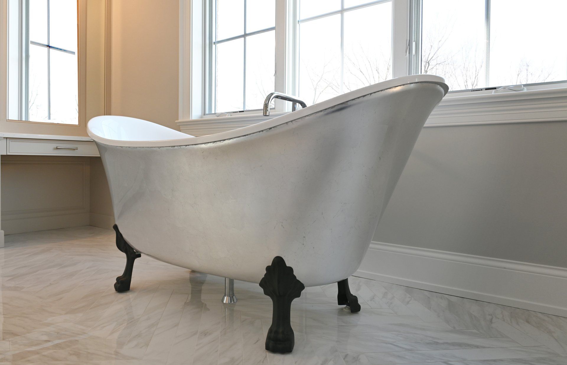 A bathtub is sitting in a bathroom next to a window.