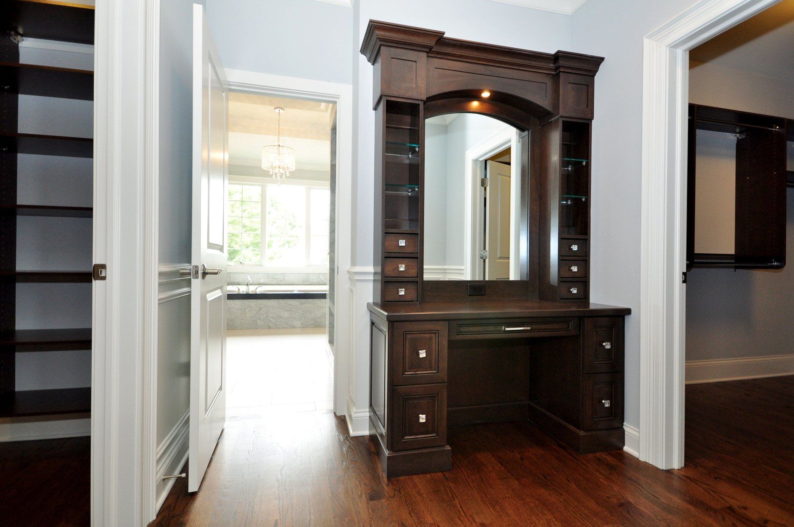 A room with a vanity and a mirror in it