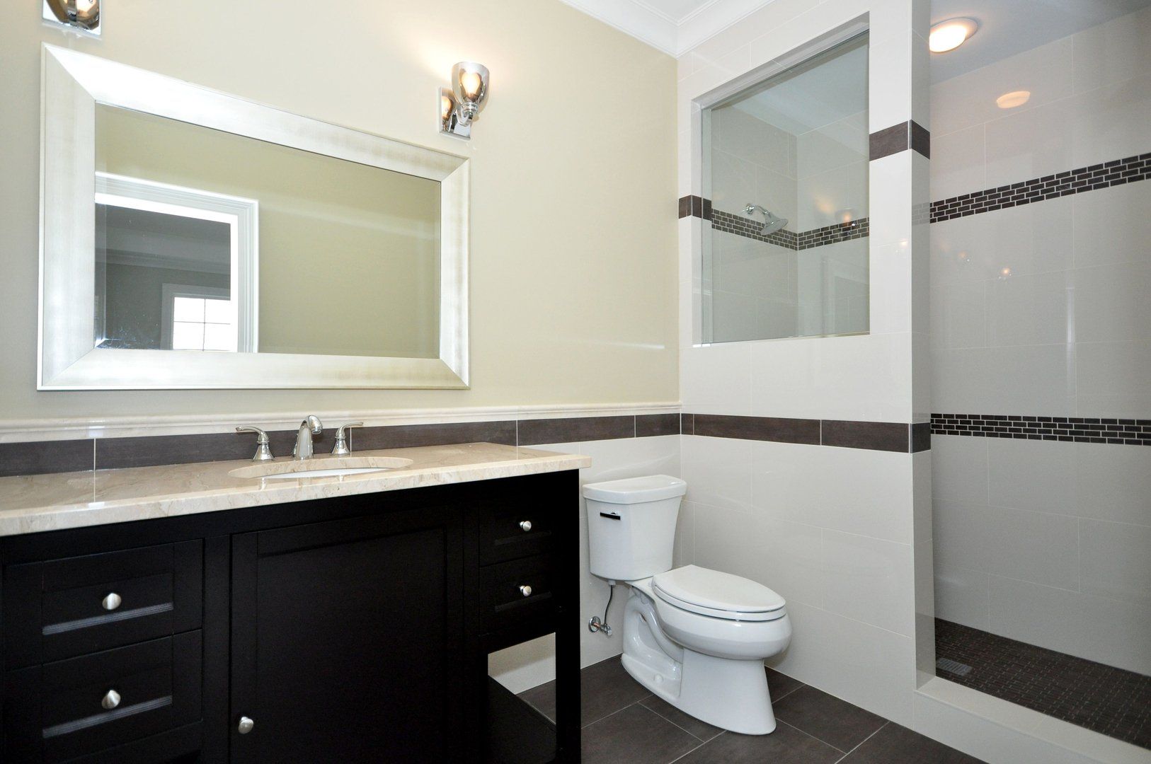 A bathroom with a toilet , sink and mirror