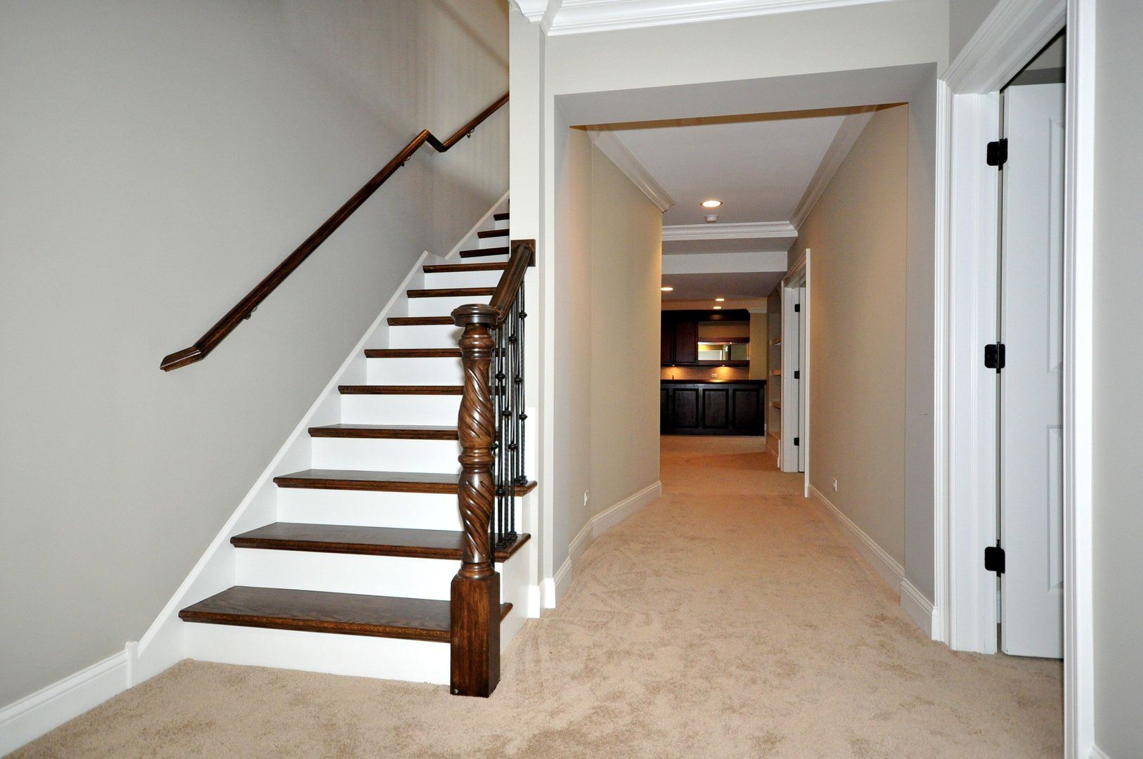 A hallway with stairs leading up to the second floor