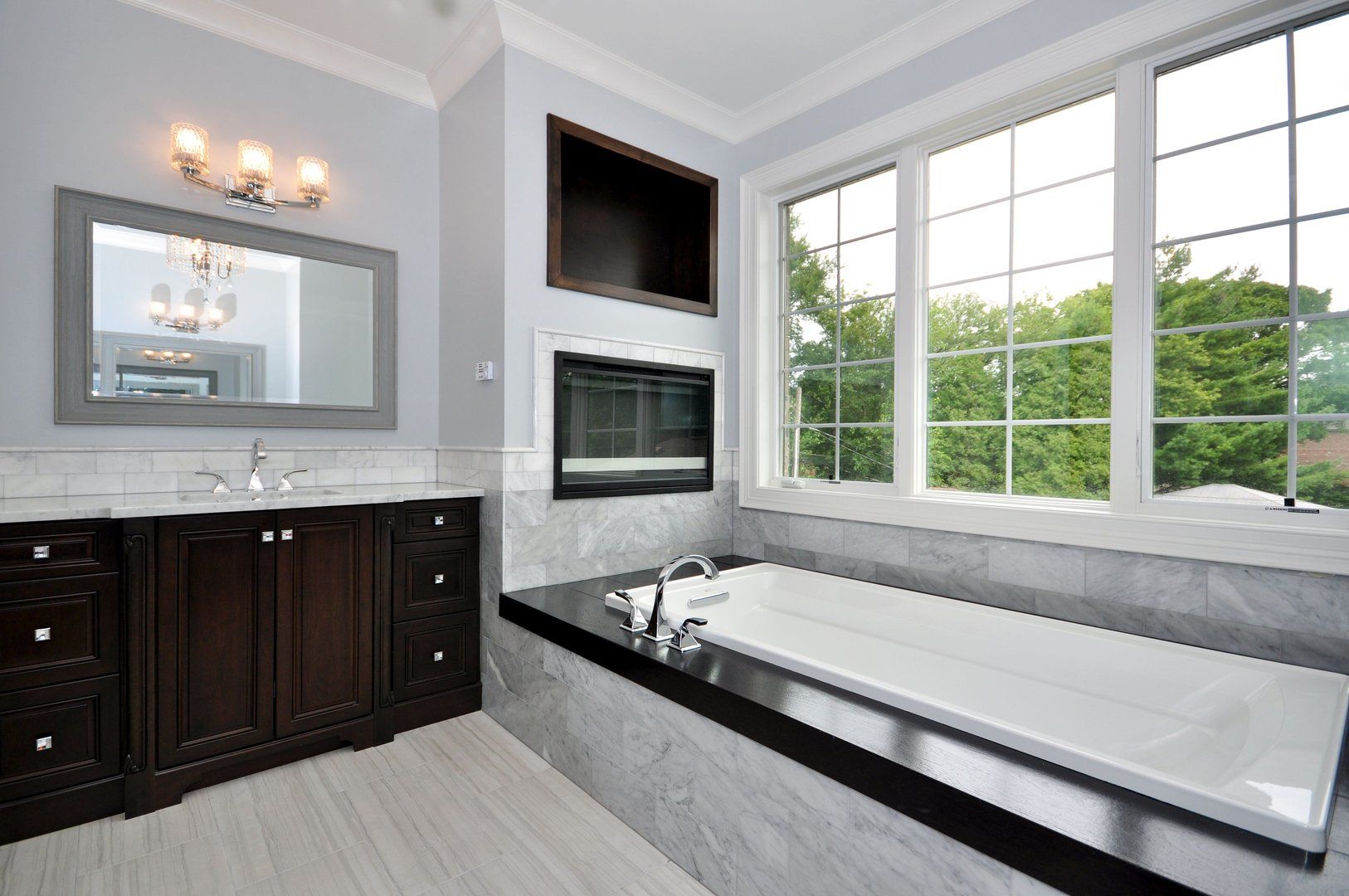 A bathroom with a large tub and two sinks