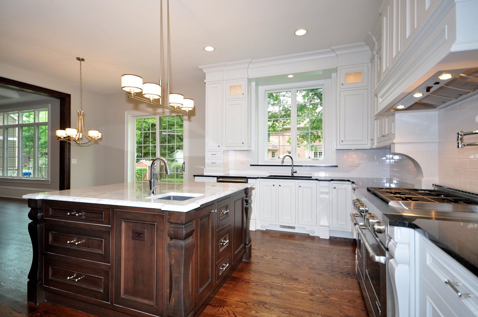 A kitchen with white cabinets and a large island
