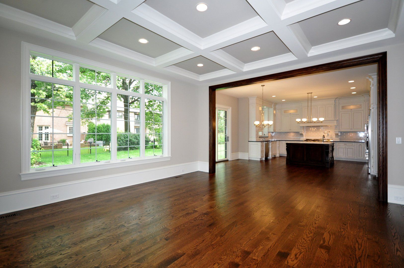 An empty room with hardwood floors and a large window