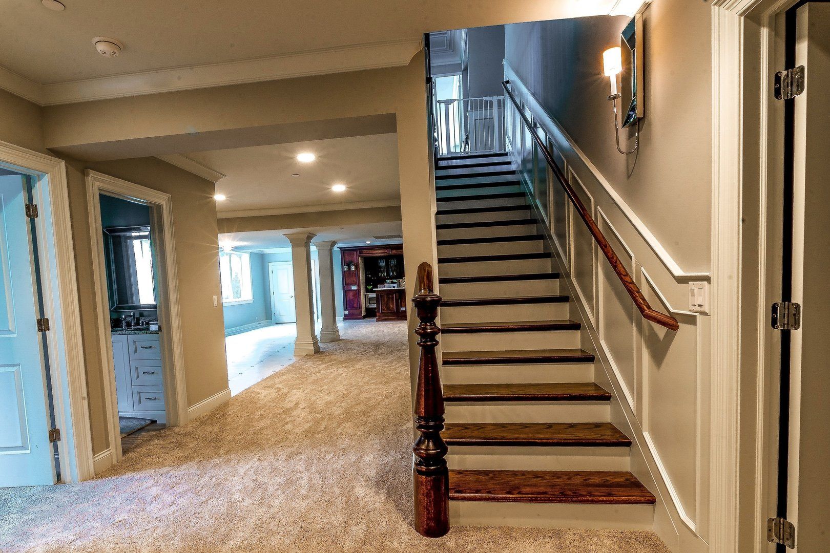 A hallway with stairs leading up to the second floor of a house.