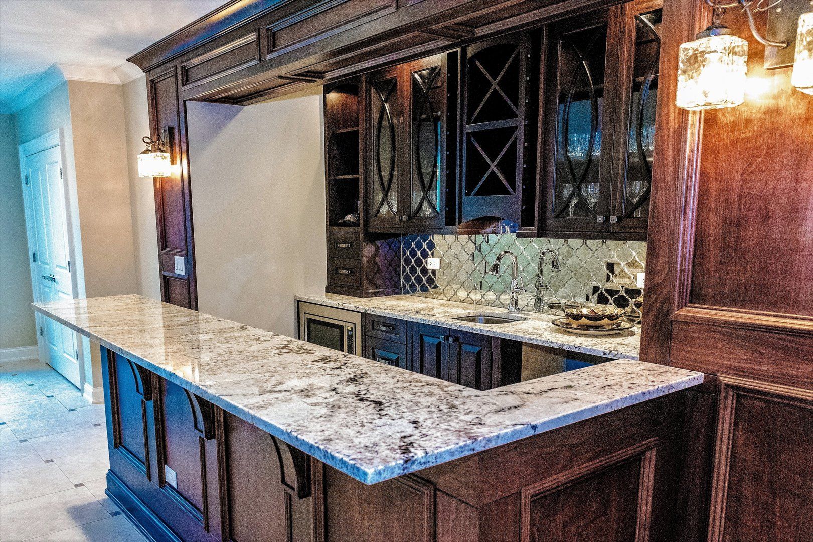 A kitchen with granite counter tops and wooden cabinets.