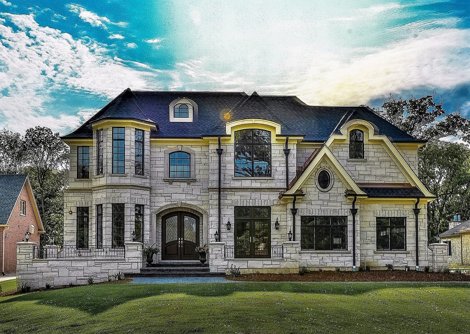 A large brick house with a blue roof is sitting on top of a lush green lawn.