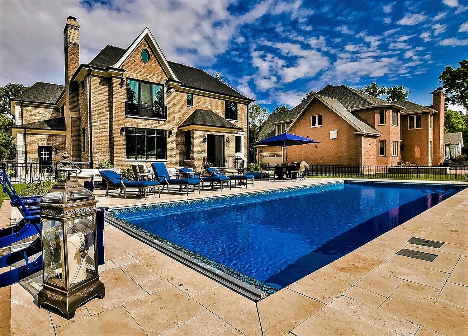 A large house with a large swimming pool in front of it