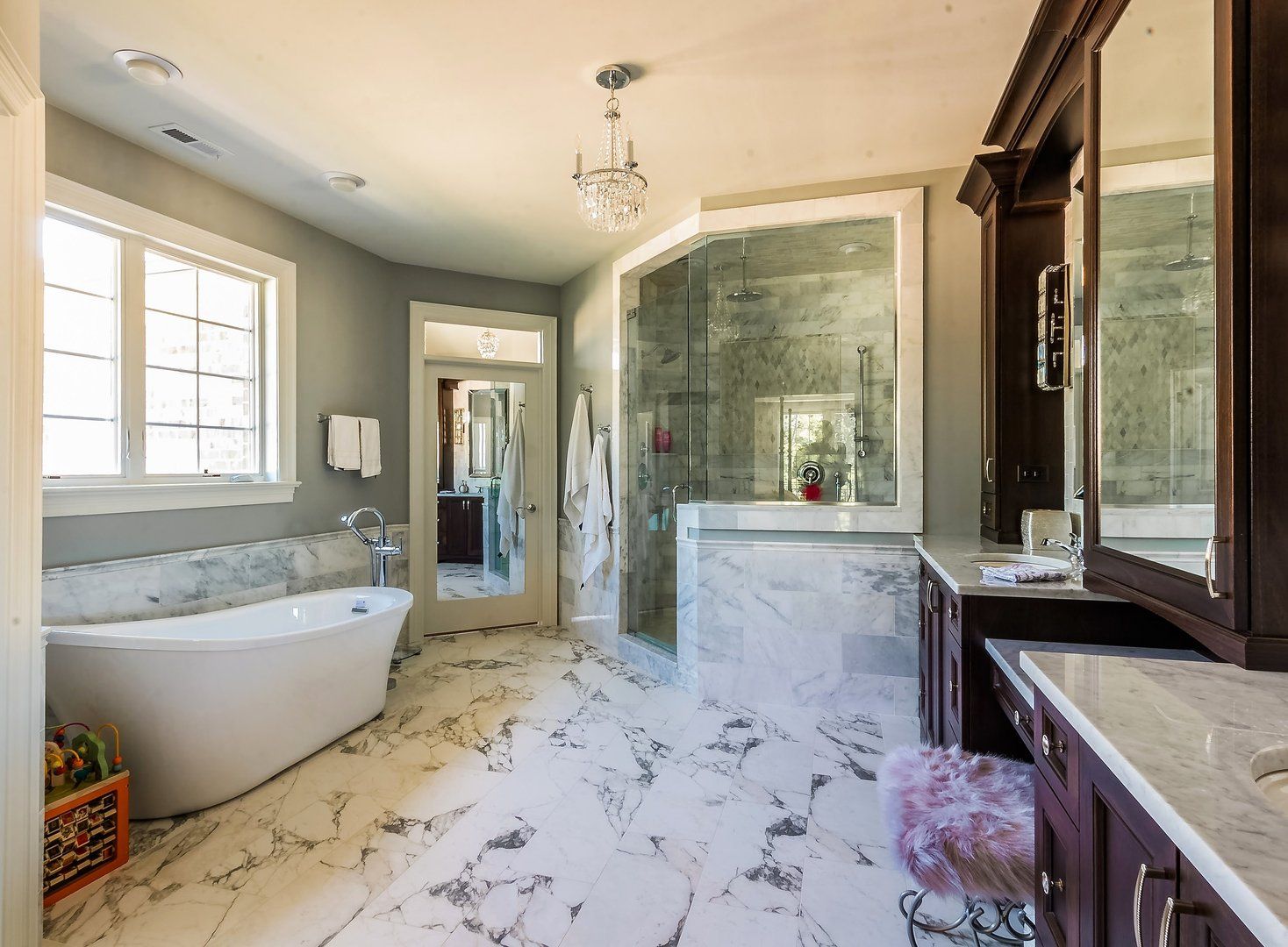 A bathroom with a bathtub , sink , mirror and walk in shower.