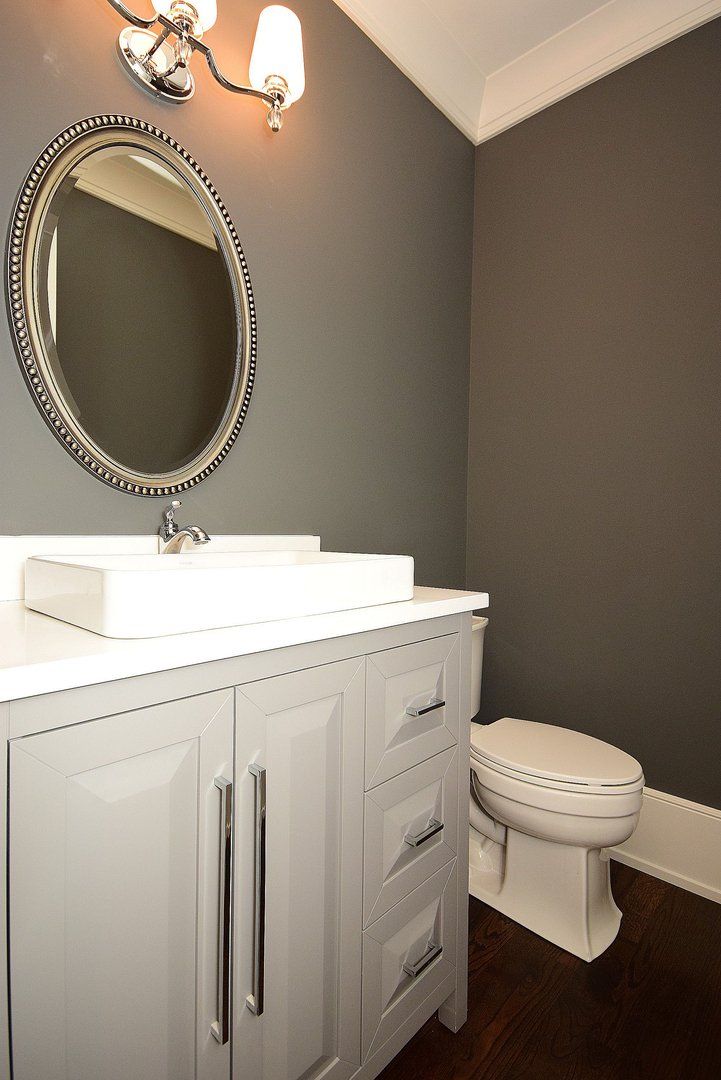 A bathroom with a sink , toilet and mirror