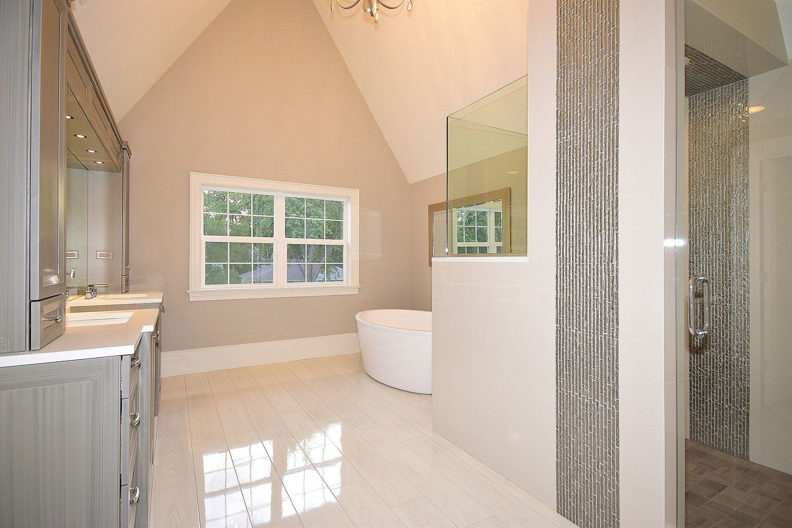A bathroom with two sinks , a tub and a shower.