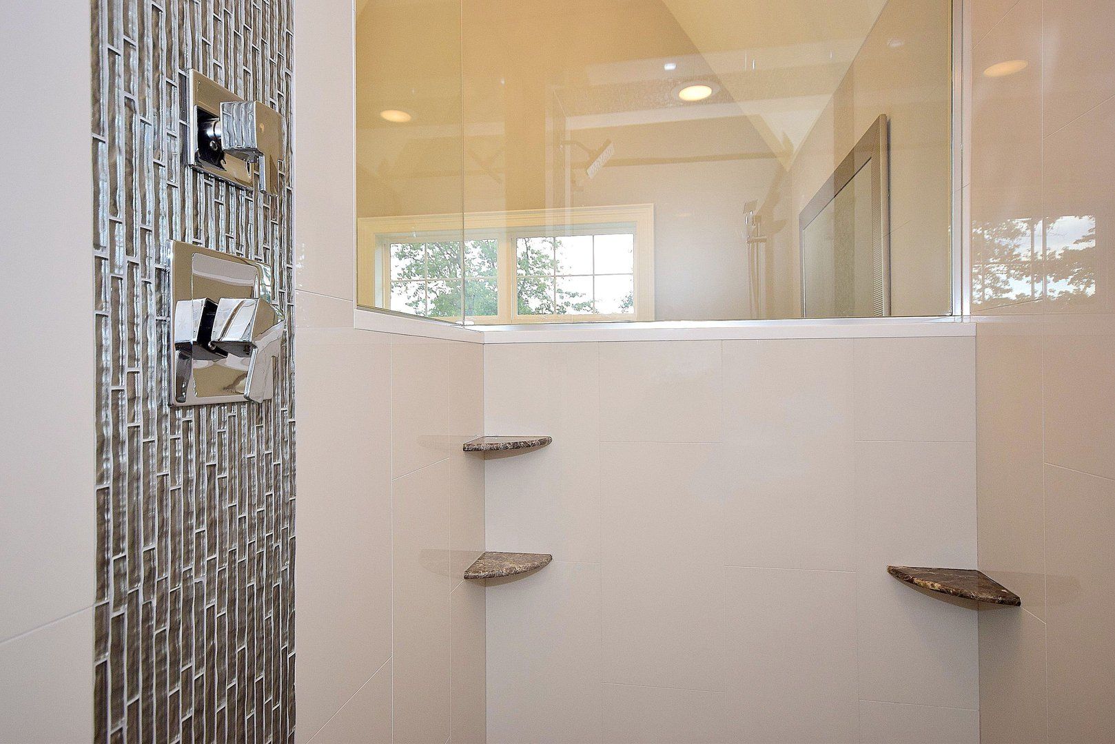 A bathroom with a walk in shower and a bathtub.