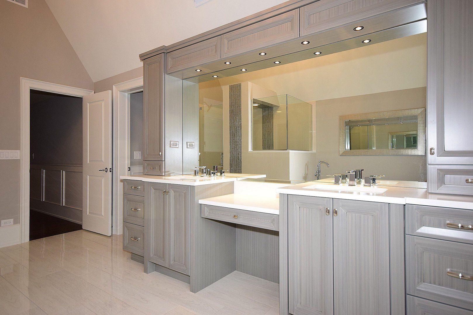 A bathroom with two sinks and a large mirror
