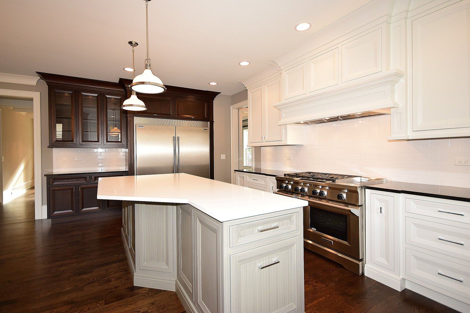 A kitchen with white cabinets and stainless steel appliances