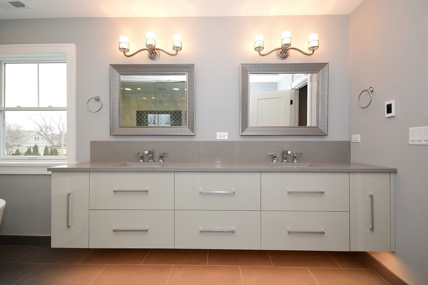 A bathroom with two sinks and two mirrors.
