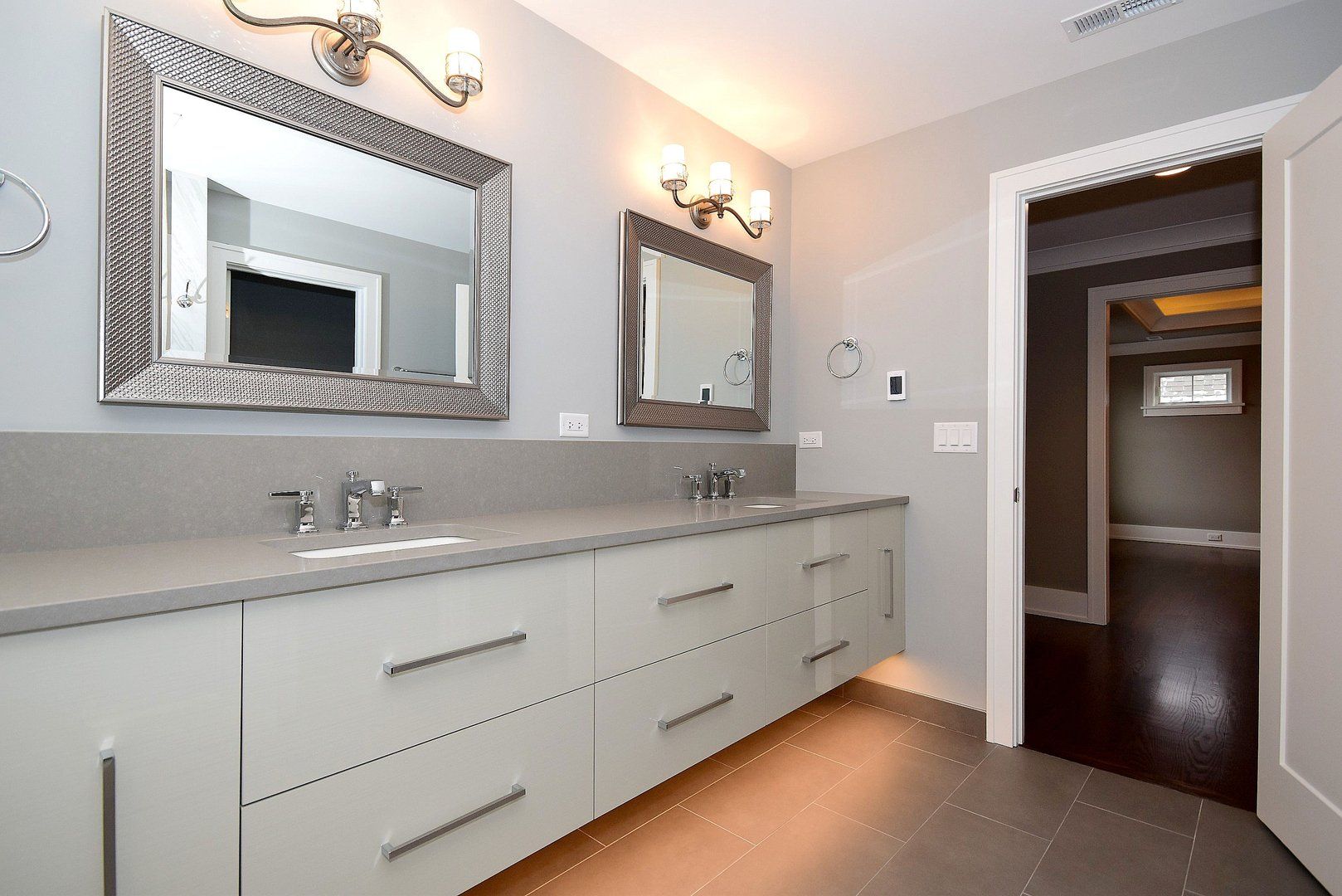 A bathroom with two sinks and two mirrors