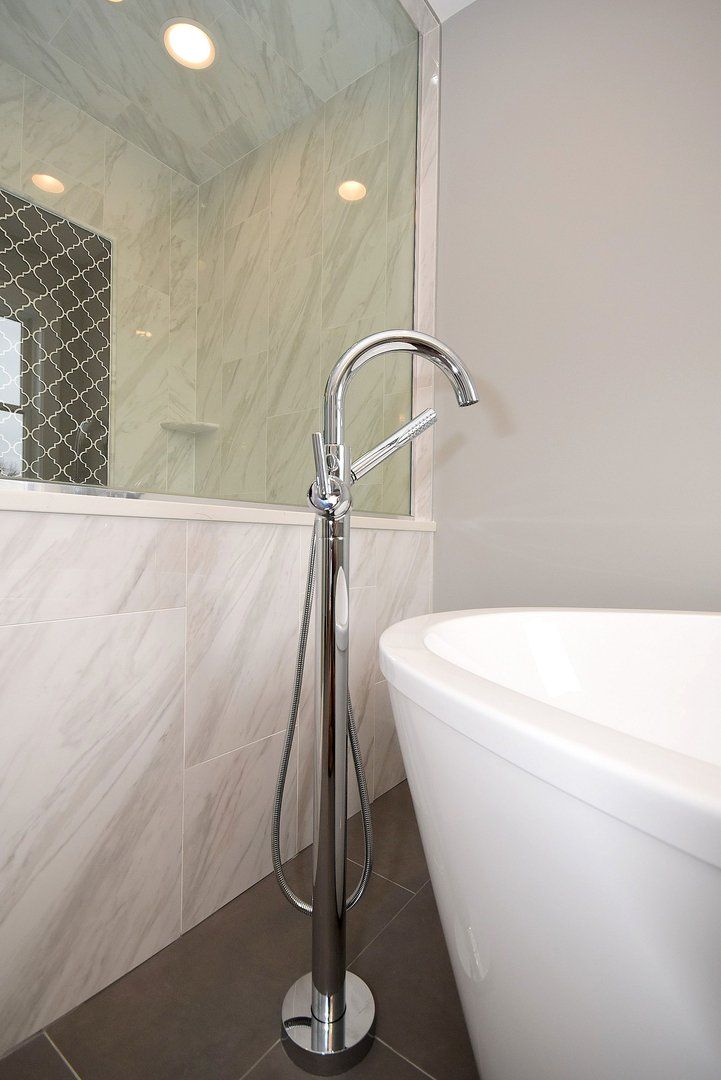 A bathroom with a bathtub and a shower.