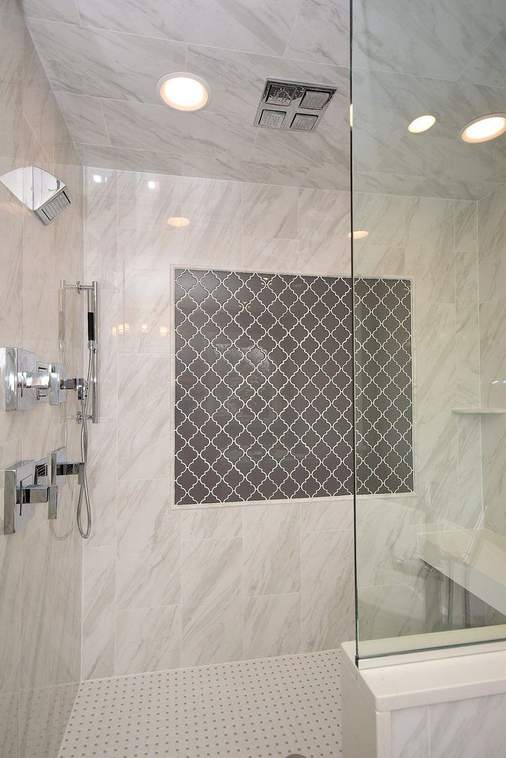 A bathroom with a walk in shower and a bathtub.