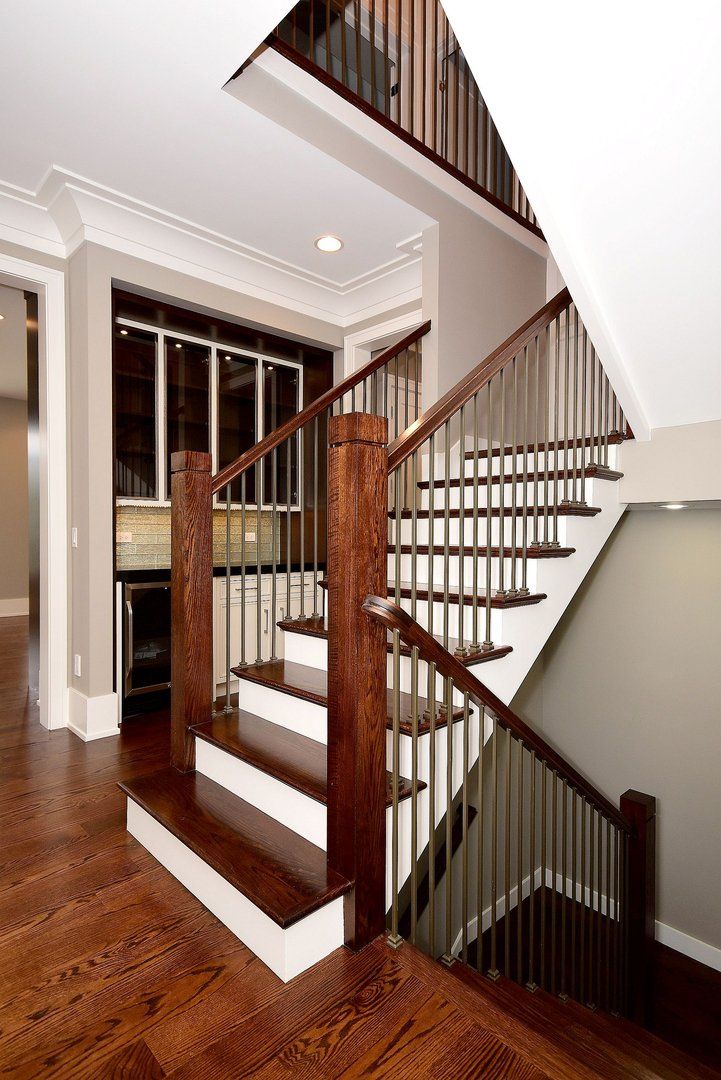 A wooden staircase with a metal railing in a house