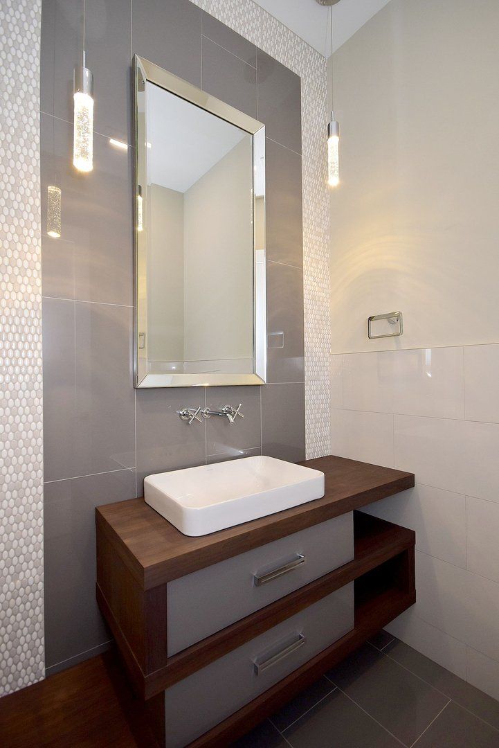 A bathroom with a sink and a mirror on the wall