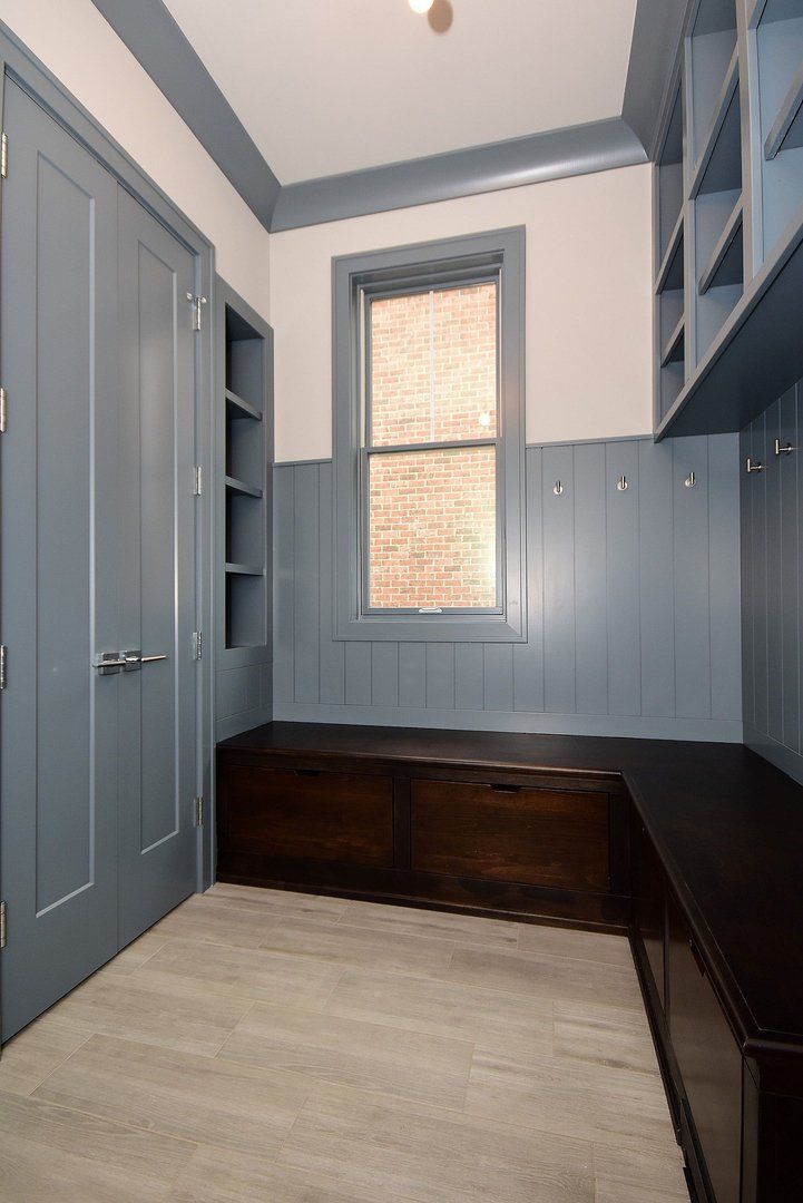 A room with a window and a bench in it