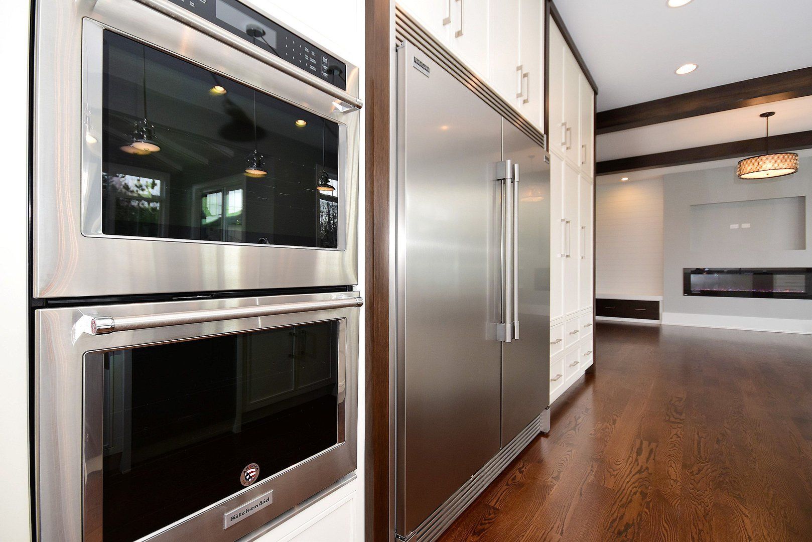 A kitchen with a stainless steel refrigerator and oven