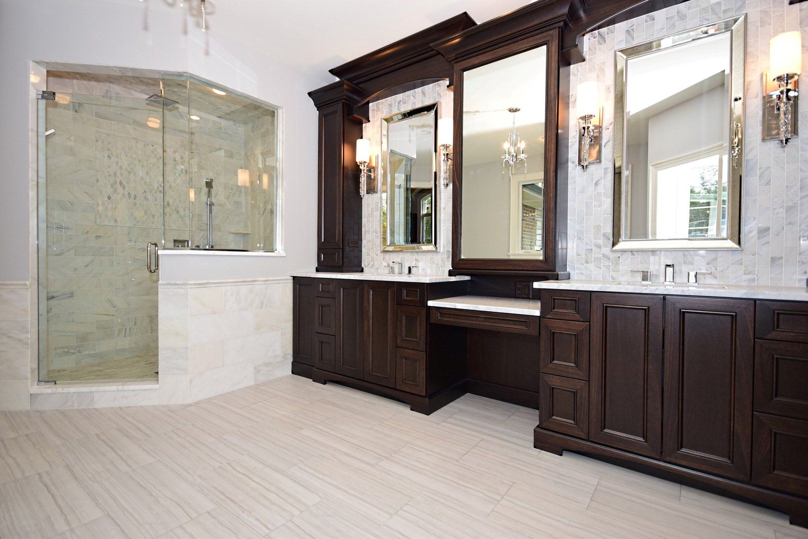 A bathroom with two sinks and a walk in shower.