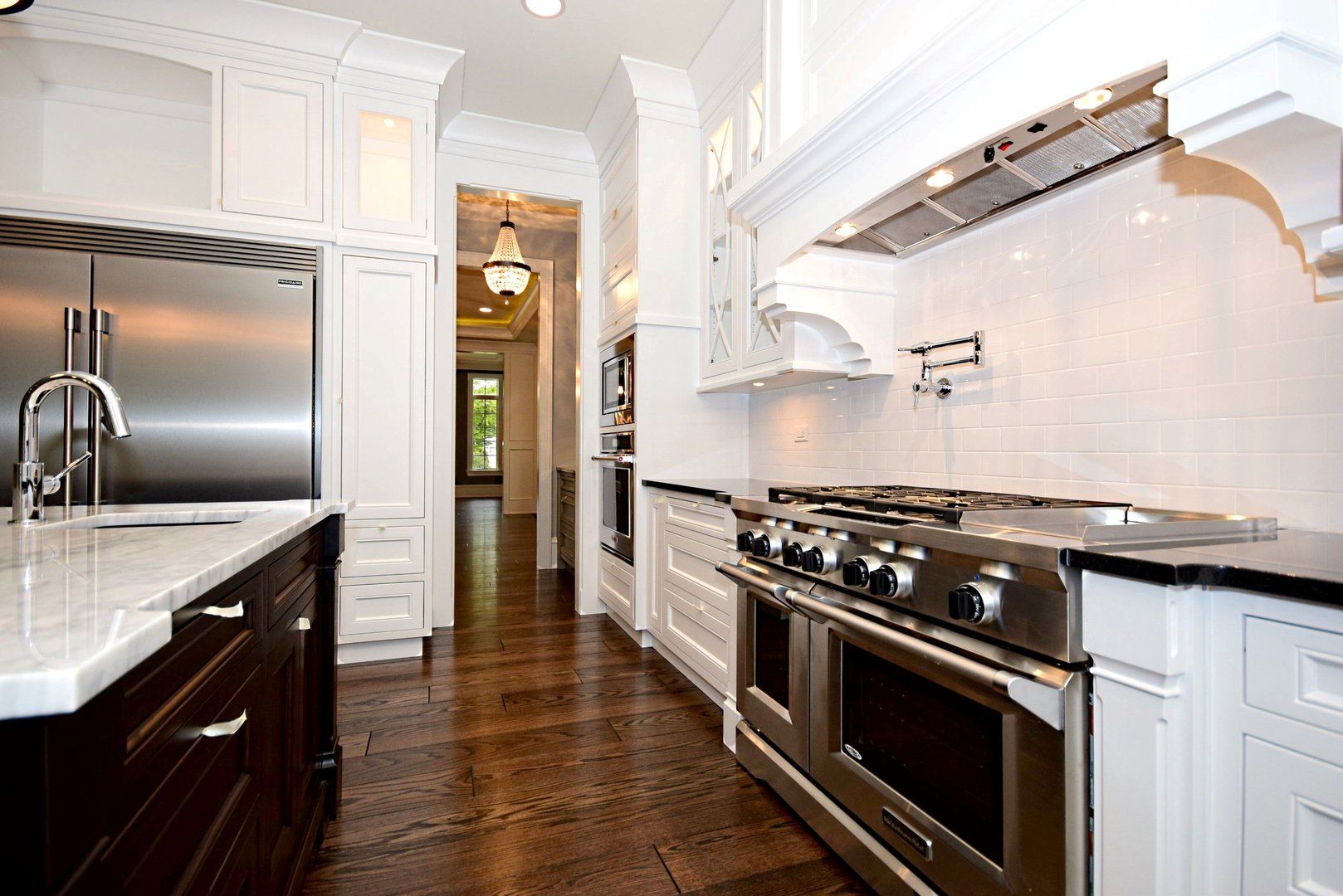 A kitchen with stainless steel appliances and white cabinets