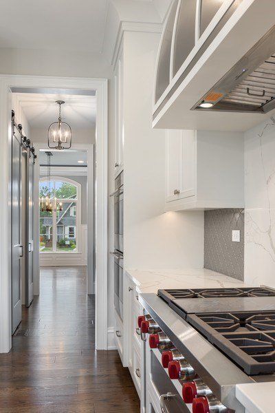 A kitchen with stainless steel appliances and white cabinets