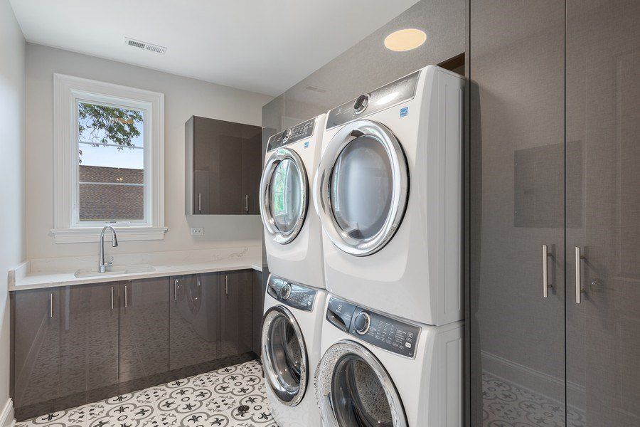 A laundry room with a washer and dryer stacked on top of each other.