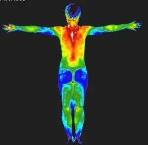 Thermal image of a person with arms outstretched, showing a heat map of body temperature.