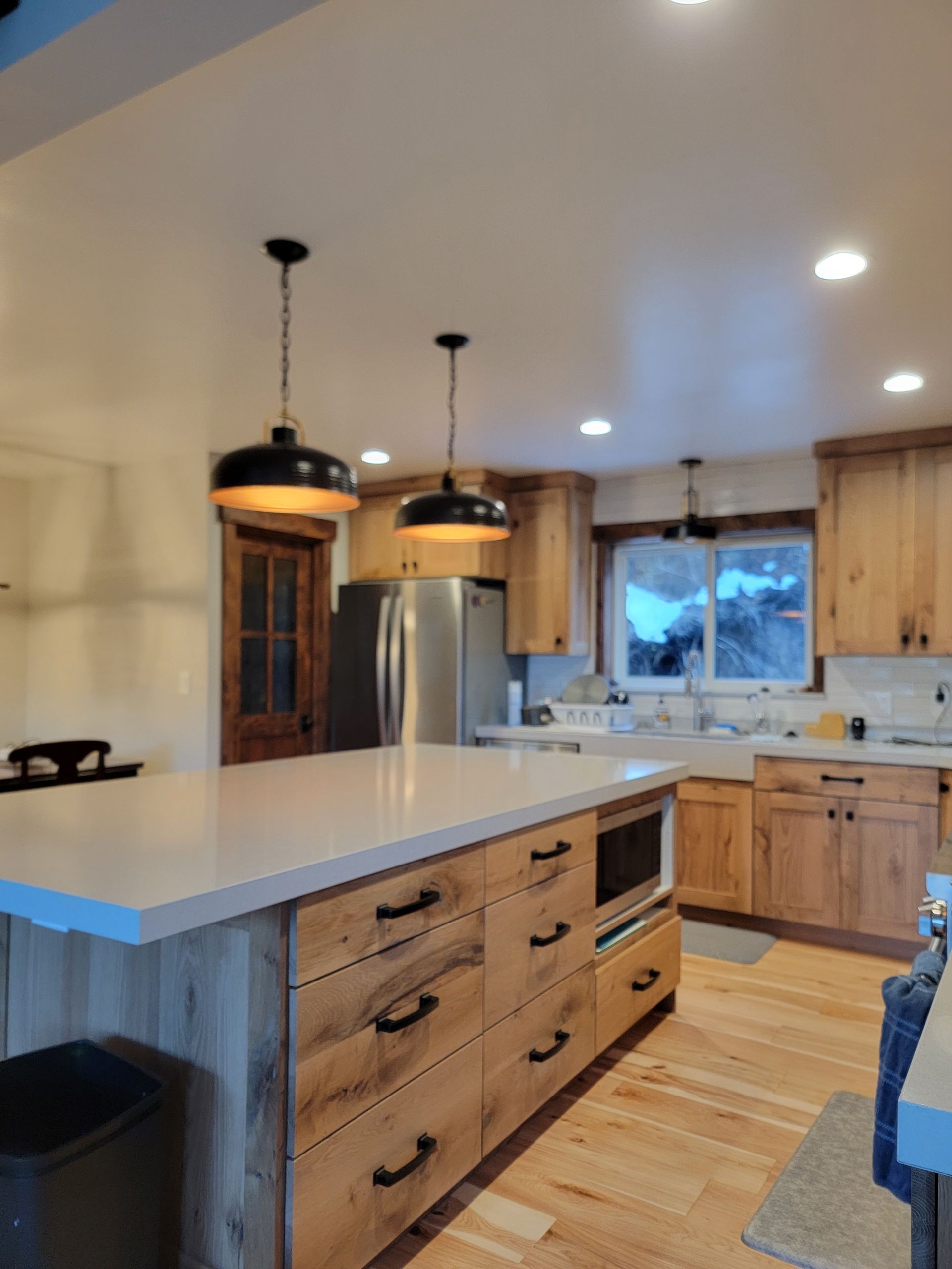 A kitchen with wooden cabinets and stainless steel appliances