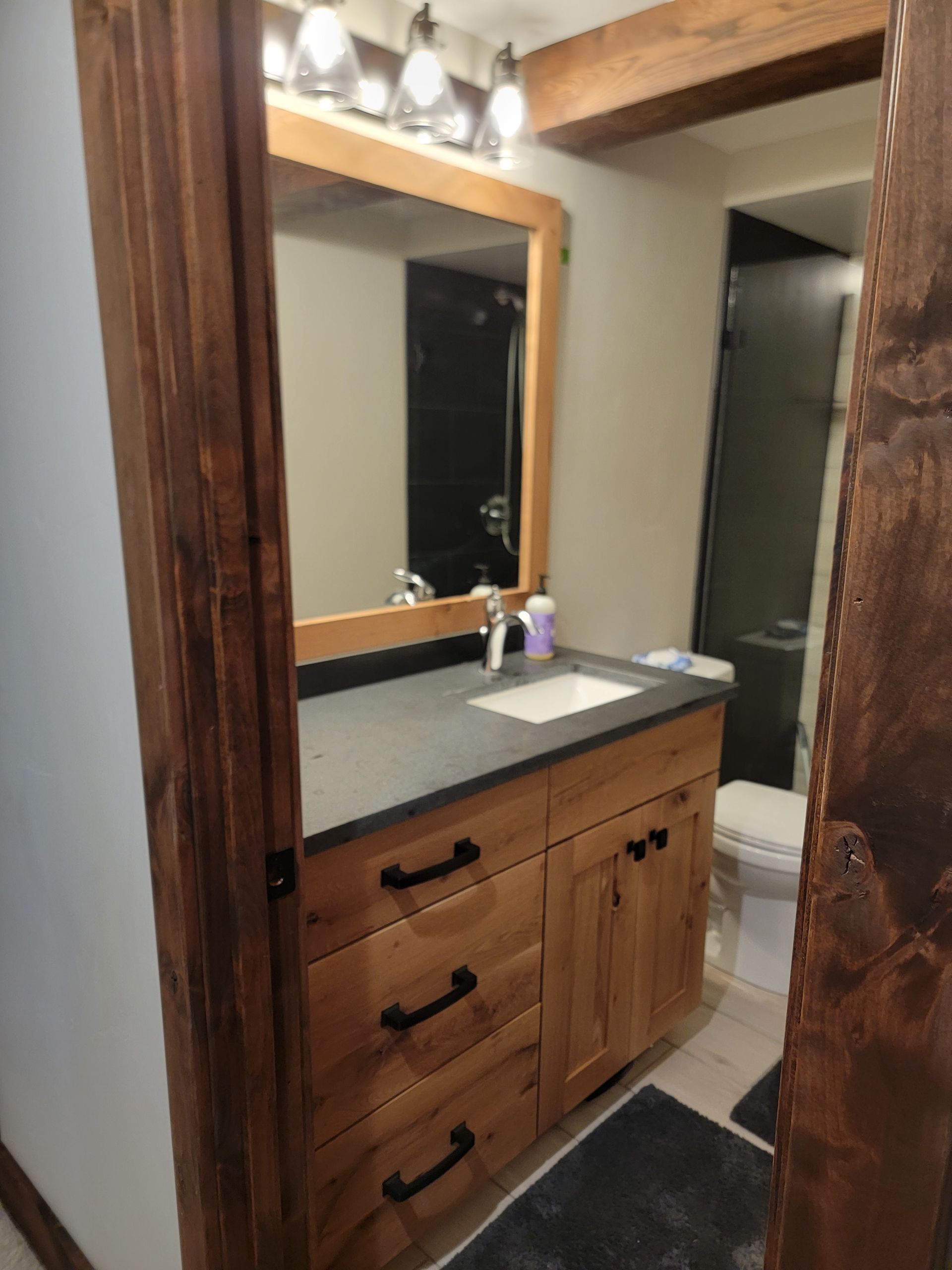 A bathroom with a sink a mirror and a toilet