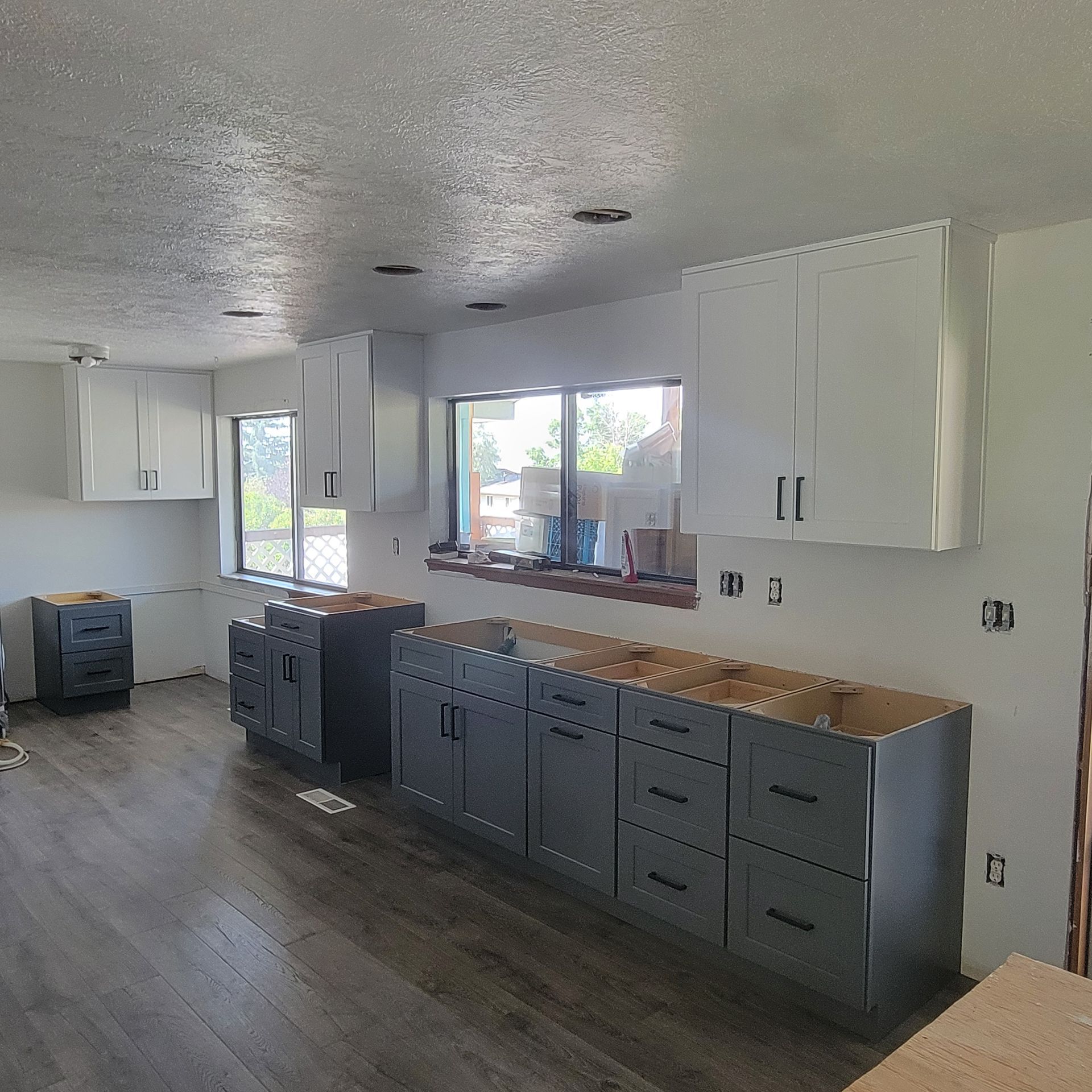 A kitchen with a lot of cabinets and a window