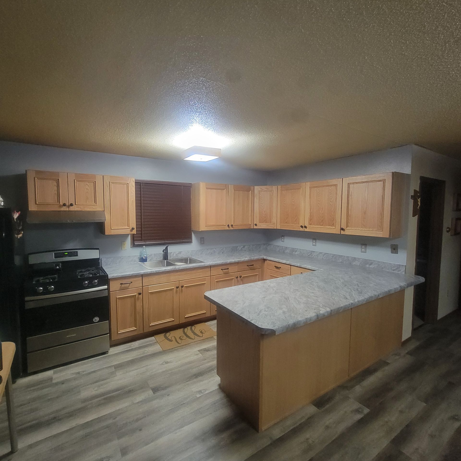 A kitchen with wooden cabinets and granite counter tops