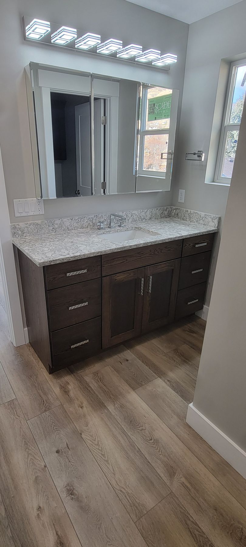 A bathroom with a double sink and a mirror.