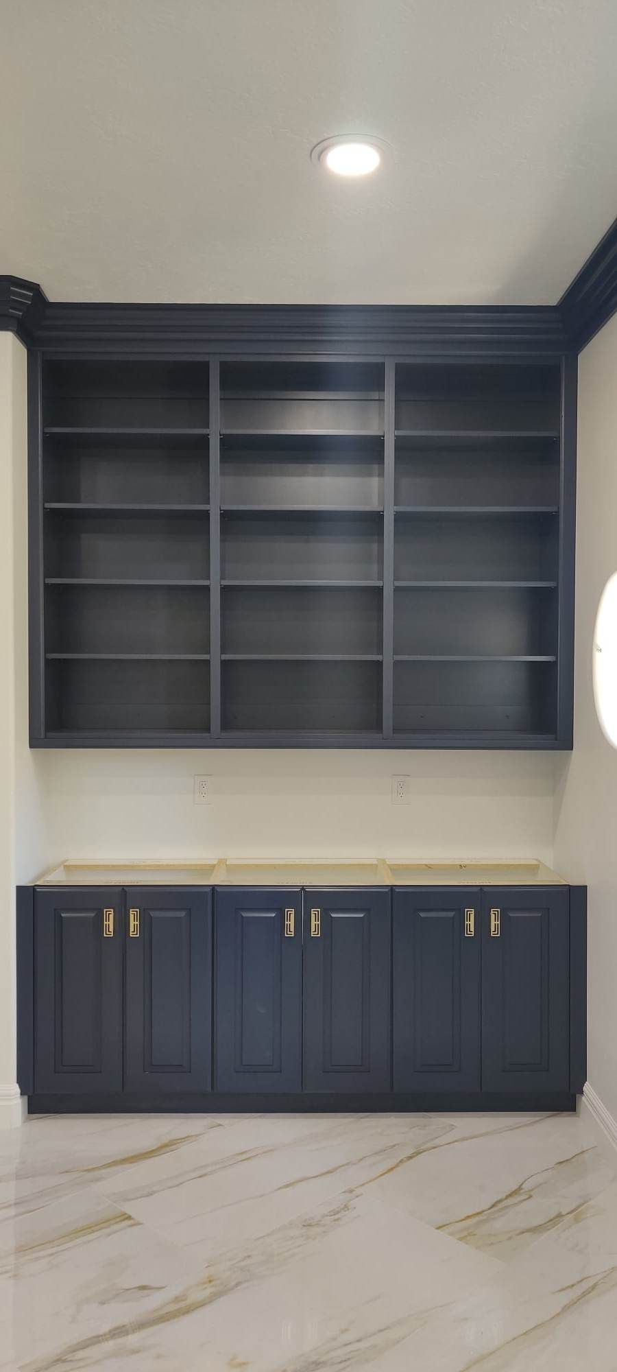 A room with a lot of shelves and cabinets in it.