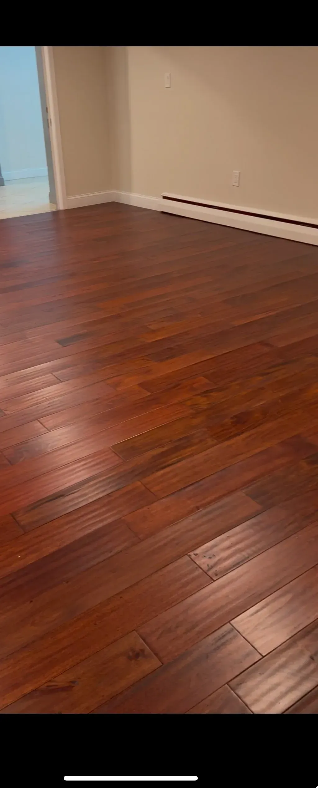 A room with hardwood floors and white walls.