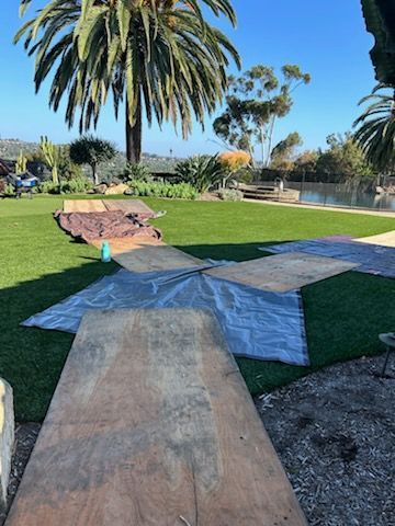 A bunch of wooden boards are sitting on top of a lush green lawn – San Diego, CA – One Tripp Tree Service