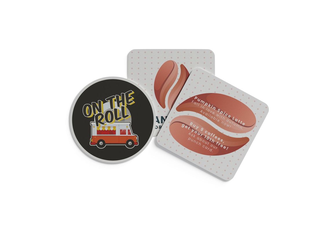 Three food-related coasters: one round with a food truck, two square with stylized coffee beans.