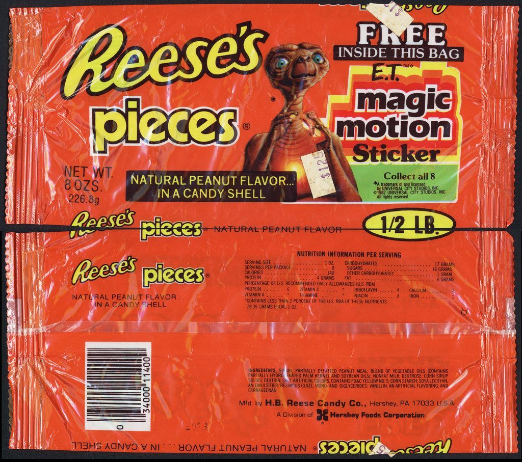 A package of reese 's pieces with a free magic motion sticker