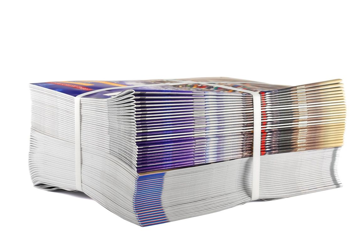 Bundle of brochures secured with white bands.
