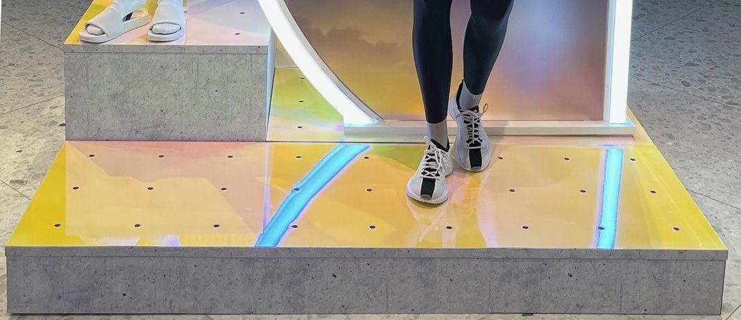 A person is walking on a yellow and blue floor.