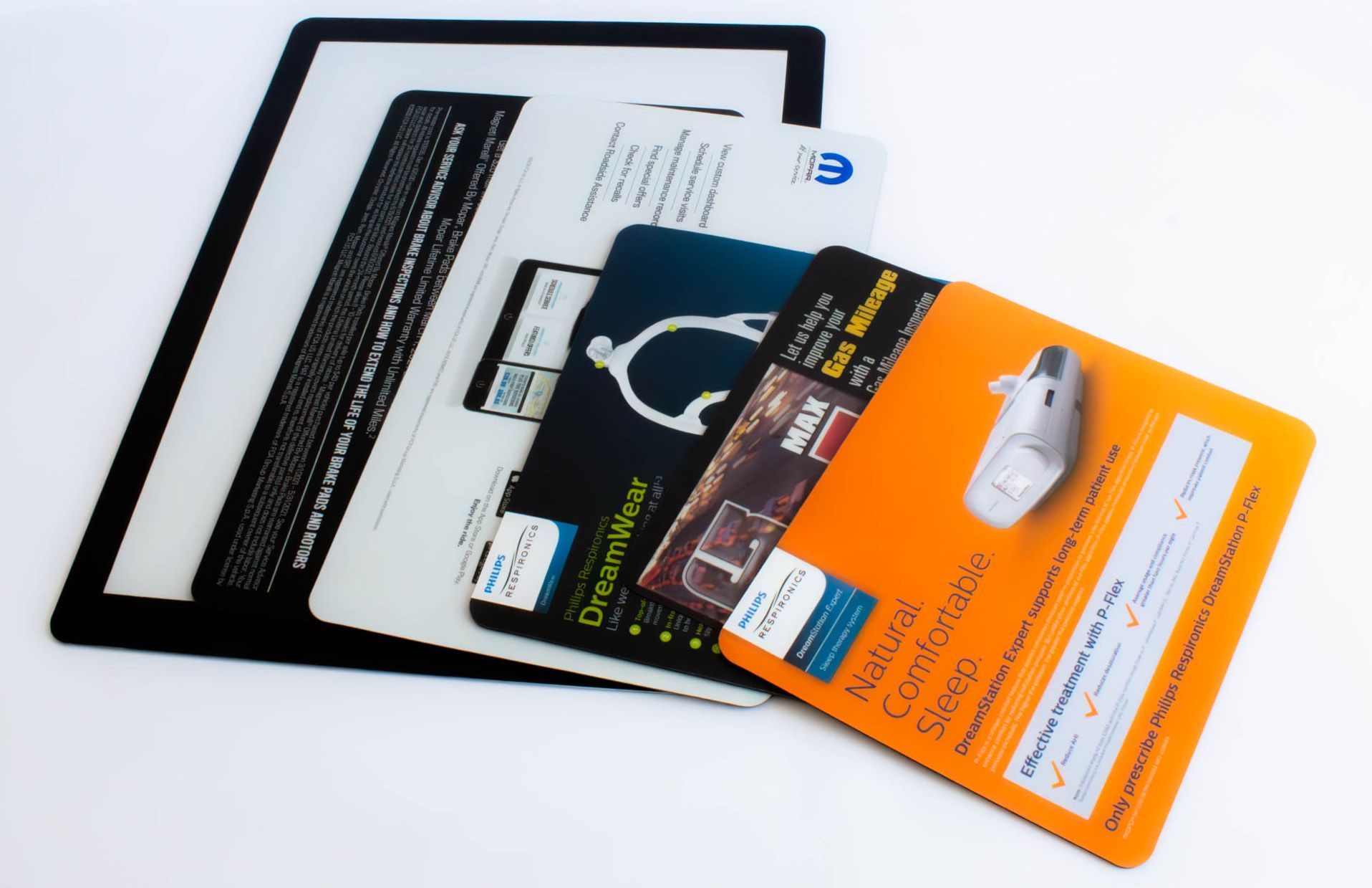 Stack of colorful promotional cards, including an orange one, on a black background, likely a tablet or display.