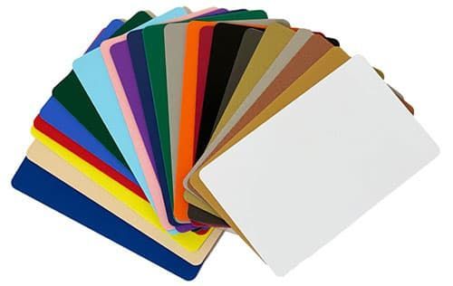 Pile of colorful rectangular cards, fanned out; includes white, gold, black, blue, and pink.