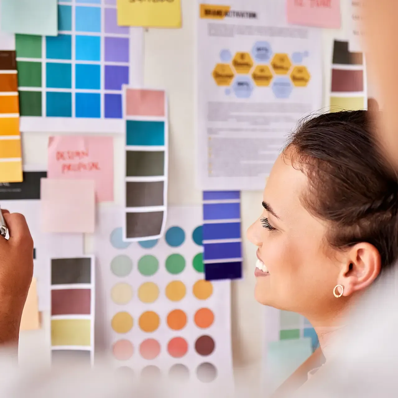 Color management in printing: woman reviewing brand color swatches on a mood board